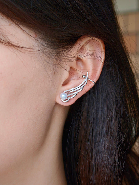 Side view of Cyrene Featherrise Wing earring on model, ear cuff climber with freshwater pearl and CZ wing, 3cm length