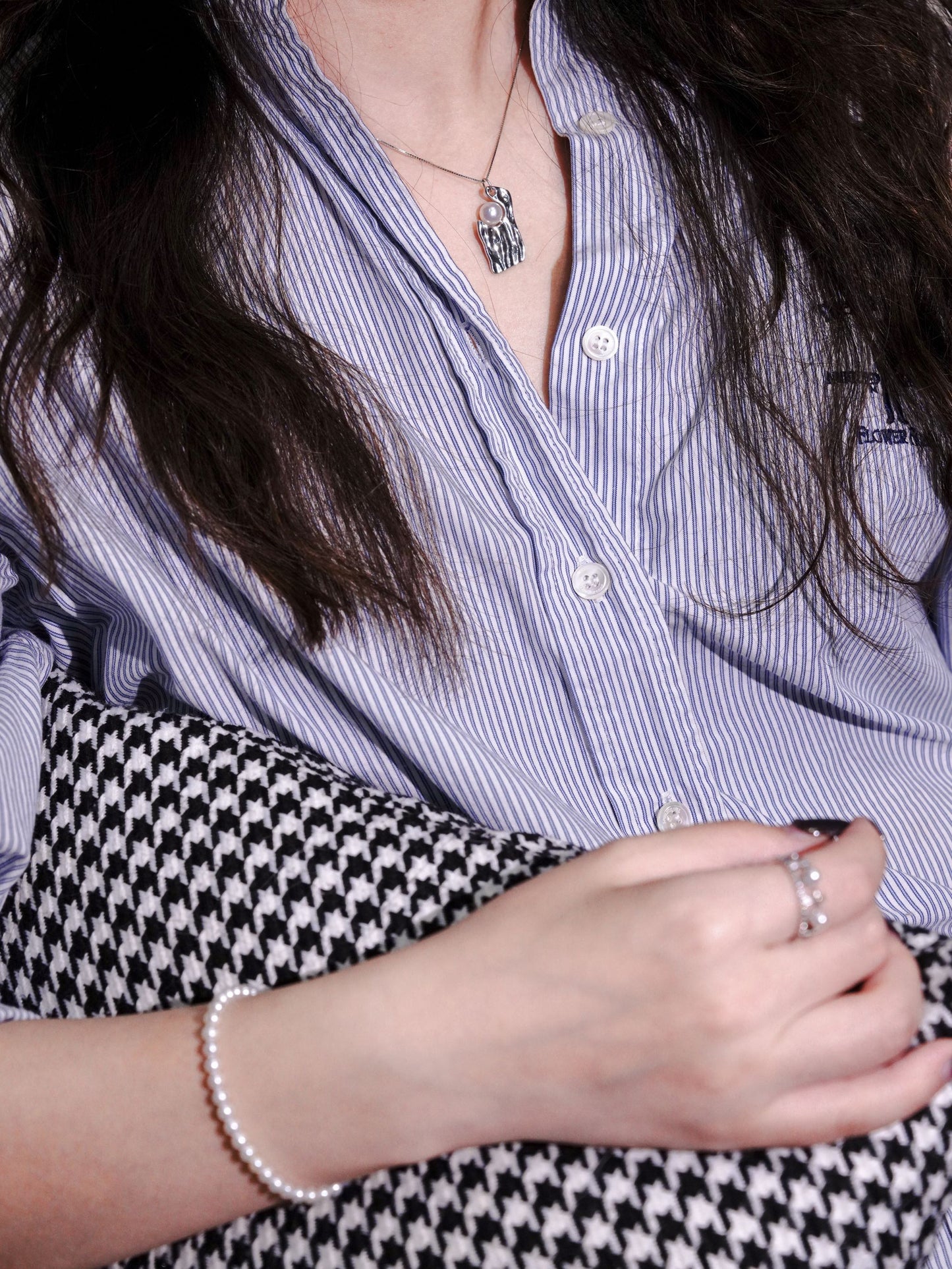 Statement silver and pearl necklace seamlessly styled with matching Cyrene pearl bracelets and rings for a cohesive contemporary look.