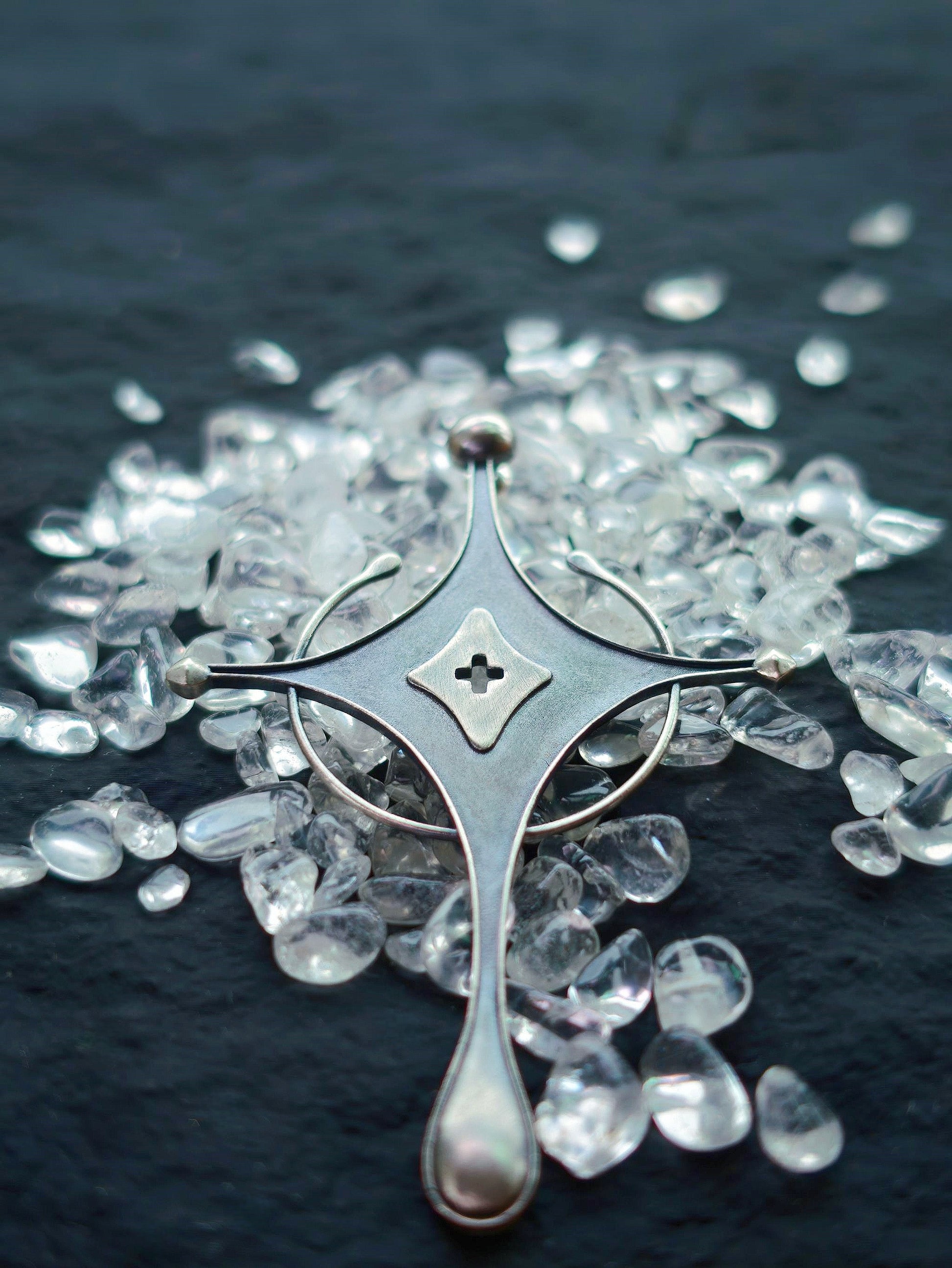 Cyrene Axiom Cross handcrafted 925 sterling silver earring flat lay, cross detail with hollow diamond center