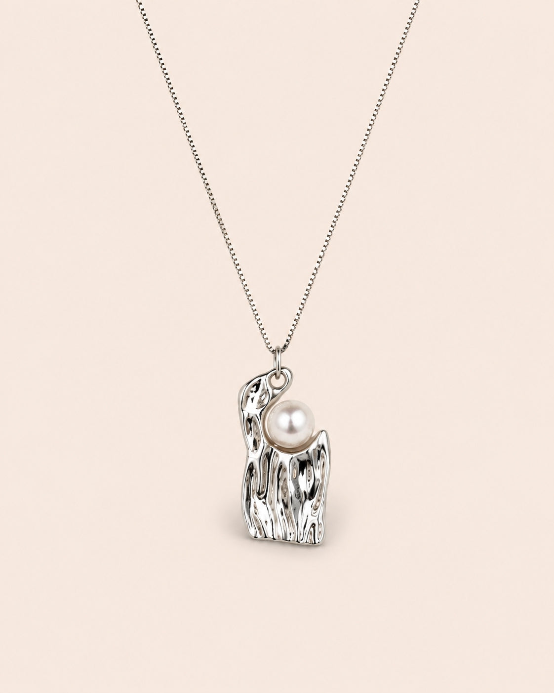 Ripple Pearl Necklace with a sculptural 925 sterling silver pendant and luminous freshwater pearl on a soft ivory background