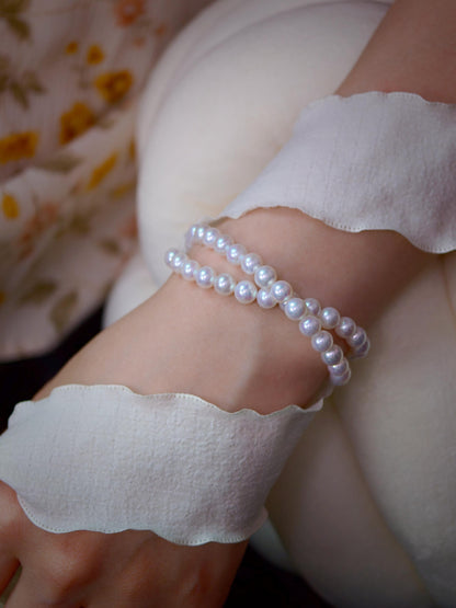 Model wearing Cyrene by Elsie's double strand 6-7mm aurora freshwater pearl bracelet on the wrist