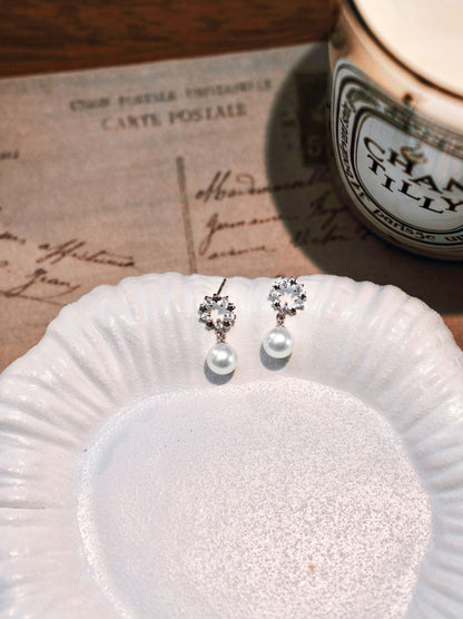 Exquisite everyday freshwater pearl jewelry by Cyrene, highlighting a brilliant small crown and halo design
