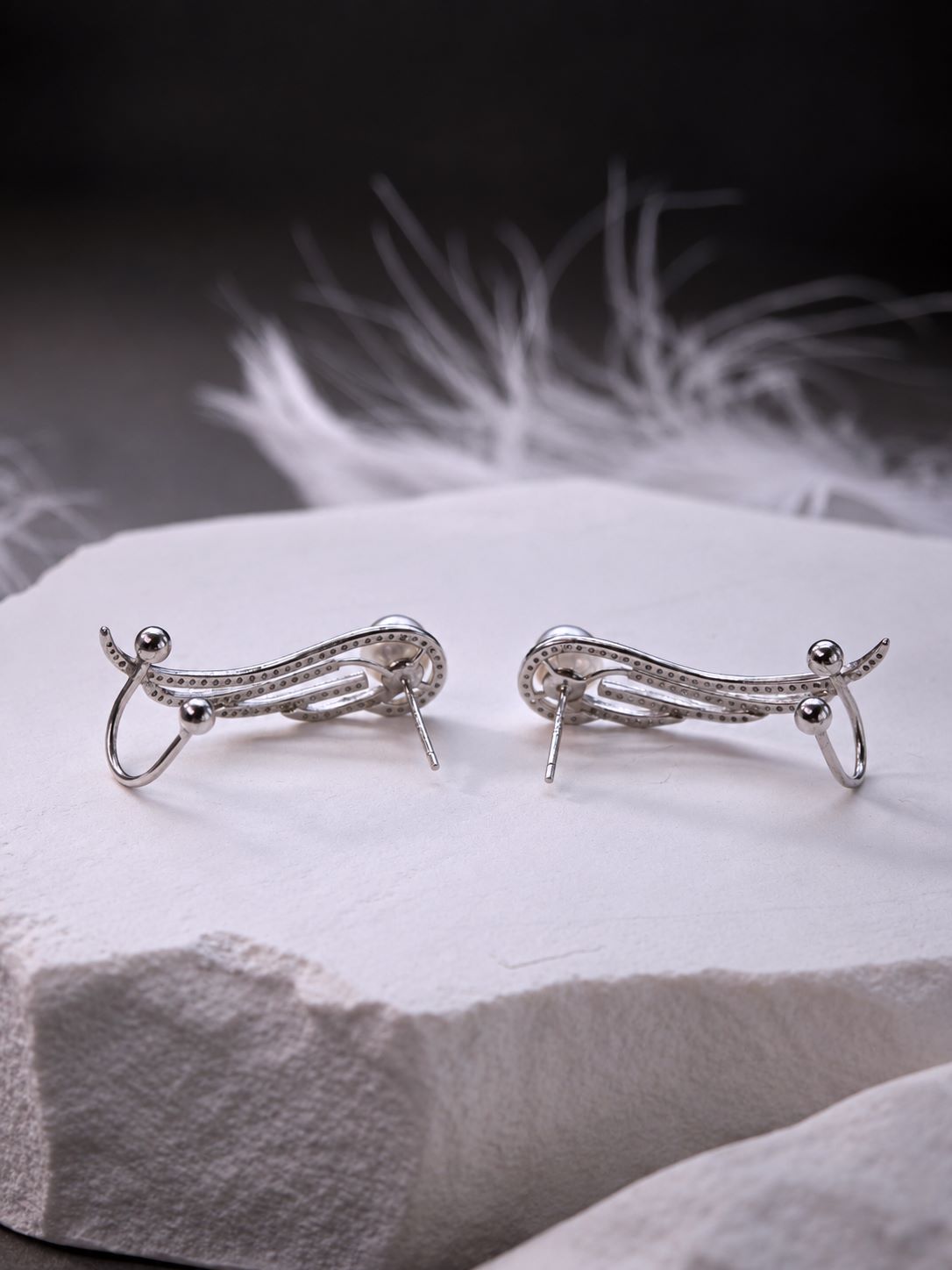 Back view of the Featherrise Wing Ear Climber showing the stud posts and adjustable sterling silver ear cuffs