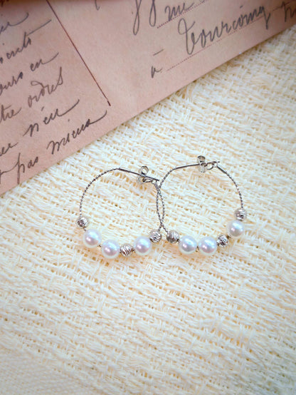 Cyrene Halo Pearl Hoop Earring pair front view, 925 silver wire hoop with freshwater pearl detail
