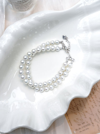 Close-up of a luxurious Cyrene double-strand bracelet featuring incredibly high-luster freshwater pearls.