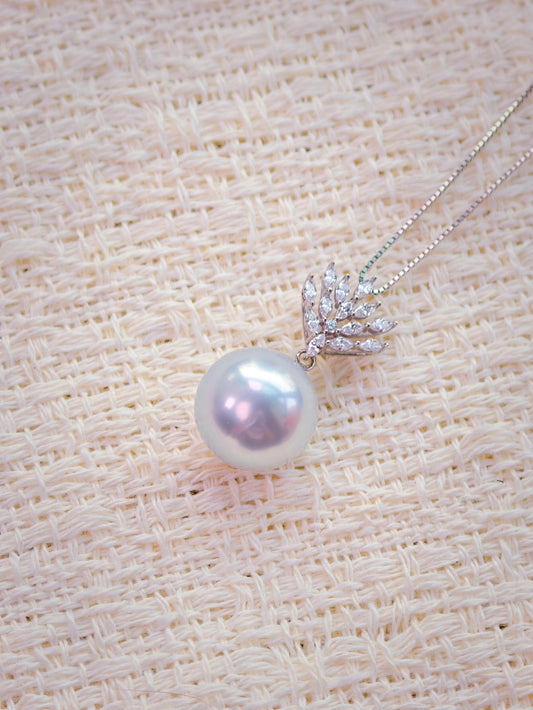 Cyrene Lone Drop Pearl Pendant close-up — 13.3mm round South Sea pearl with 18K white gold and CZ leaf setting