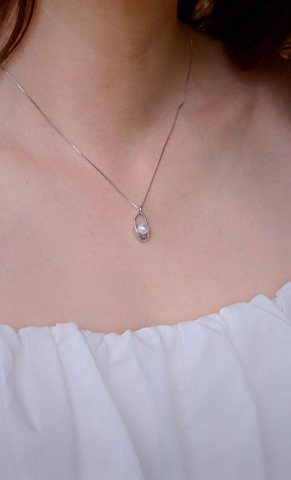 on-model-lace.pngCyrene Loop Pearl Necklace on neck with lace neckline — minimalist silver pendant with freshwater pearl detail