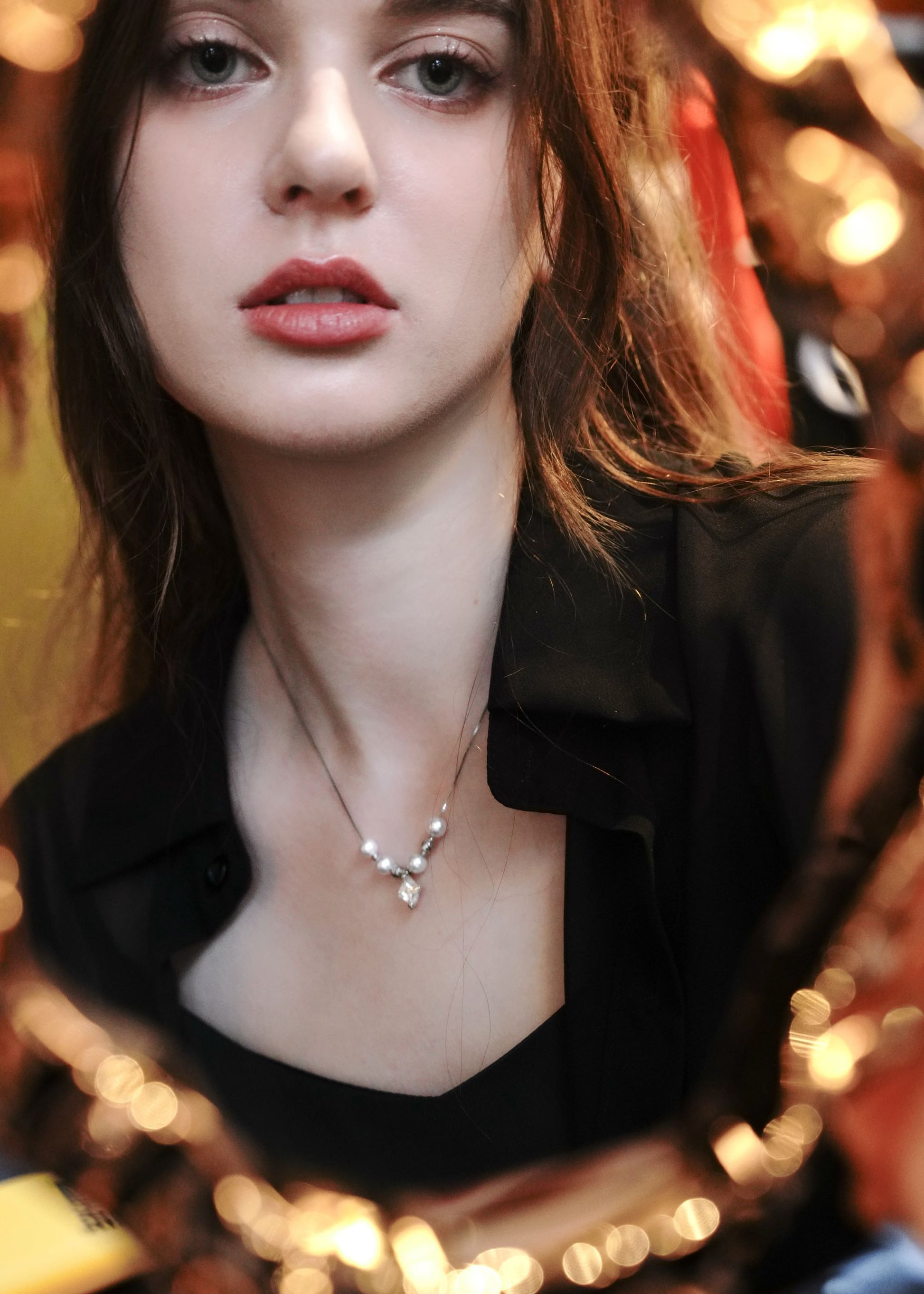 Female model wearing a minimalist 925 sterling silver pearl necklace from Cyrene.