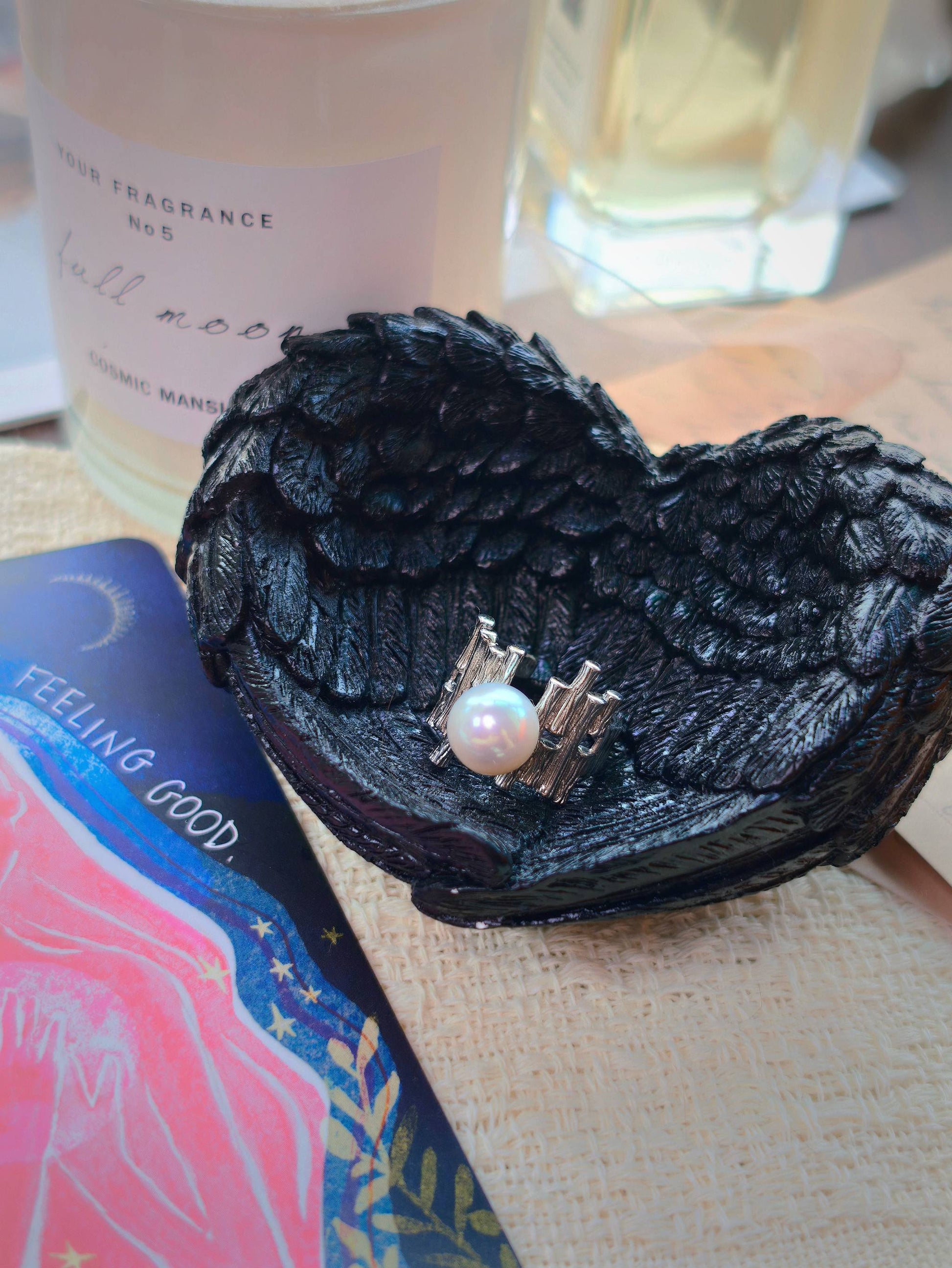 9-10mm round freshwater pearl ring by Cyrene by Elsie displayed in a black wing-shaped dish