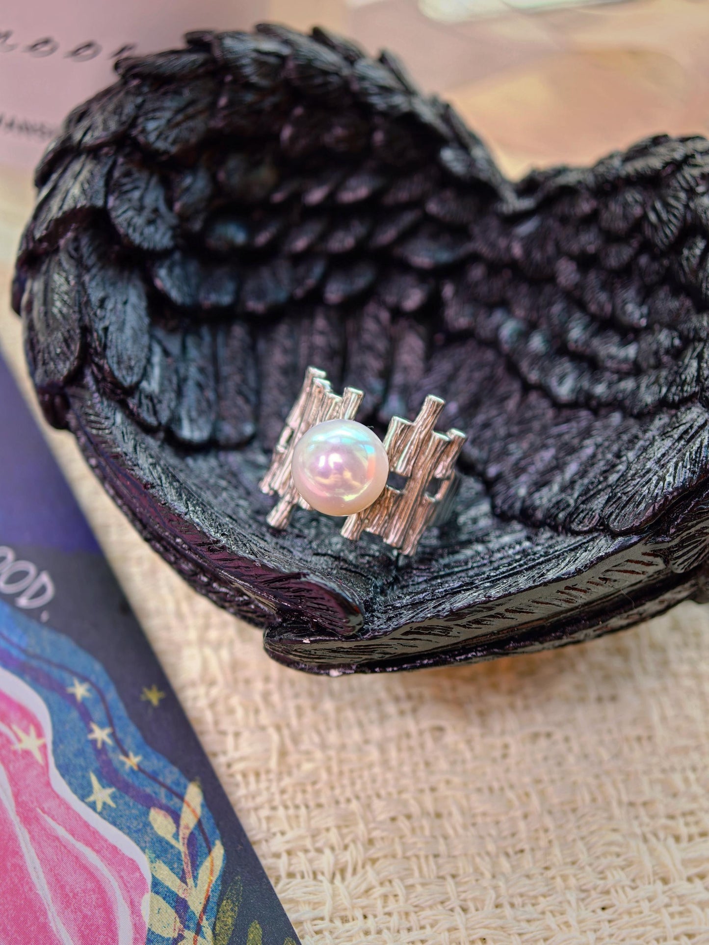 Close-up of the round, flawless 9-10mm pearl set in the Palisade Pearl Ring's silver lattice band