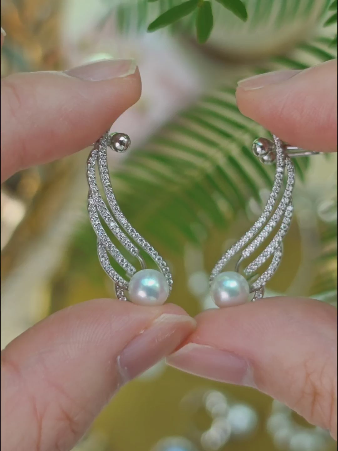 Close-up video of the Featherrise Wing Ear Climber showing its pearl and pavé CZ details, back structure and how the adjustable ear cuff is worn