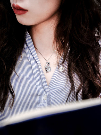 A sharp and professional boss lady look featuring Cyrene's silver wave pearl necklace layered perfectly over a striped shirt.