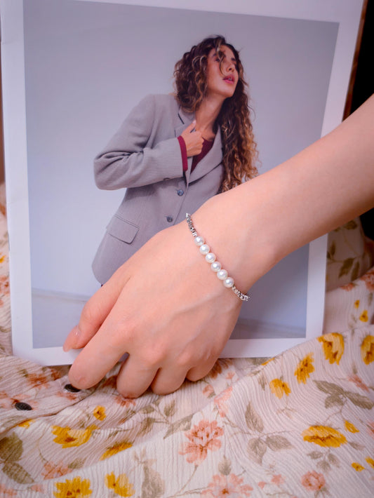 Model wearing Cyrene Relic Fragment Pearl Bracelet, 925 silver and freshwater pearl bracelet on wrist
