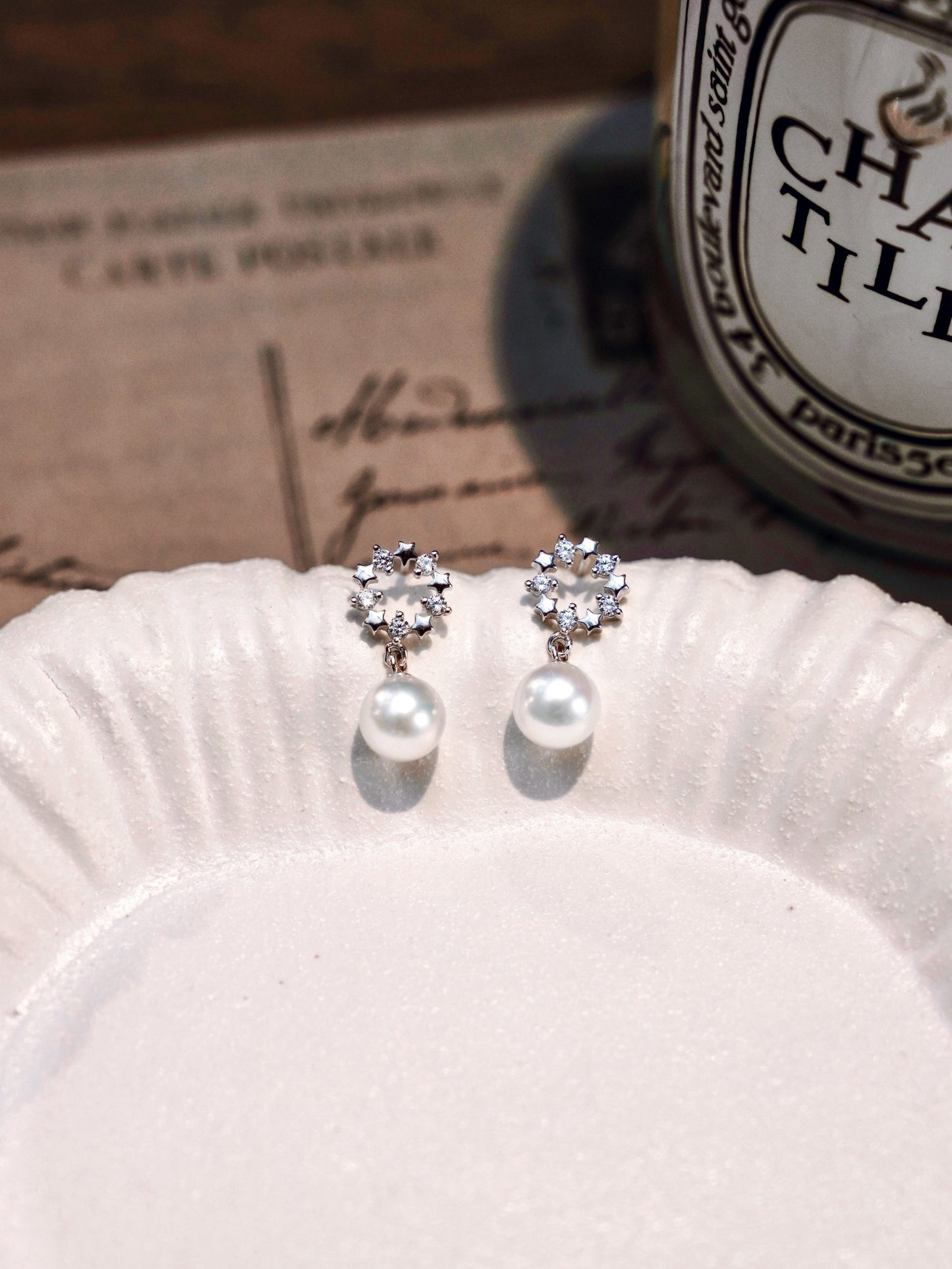 Romantic vintage aesthetic showcasing Cyrene's delicate crown pearl studs with a radiant freshwater pearl drop