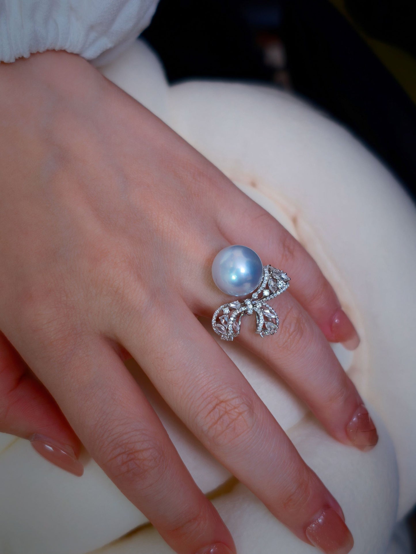 Cyrene Solitaire Bow Pearl Ring detail shot — South Sea pearl and pavé diamond bow on hand