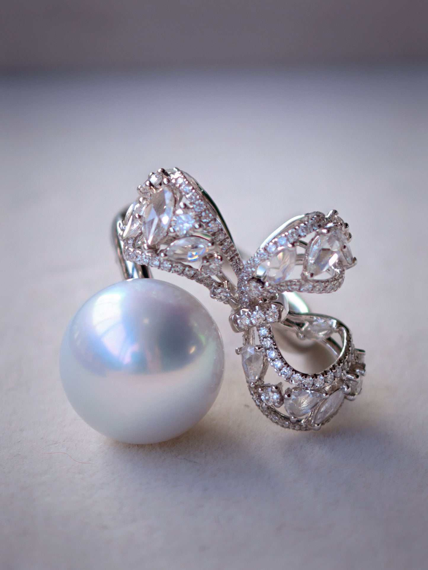 Cyrene Solitaire Bow Pearl Ring — 18K white gold genuine diamond bow ring with 13.1mm round South Sea pearl, studio detail