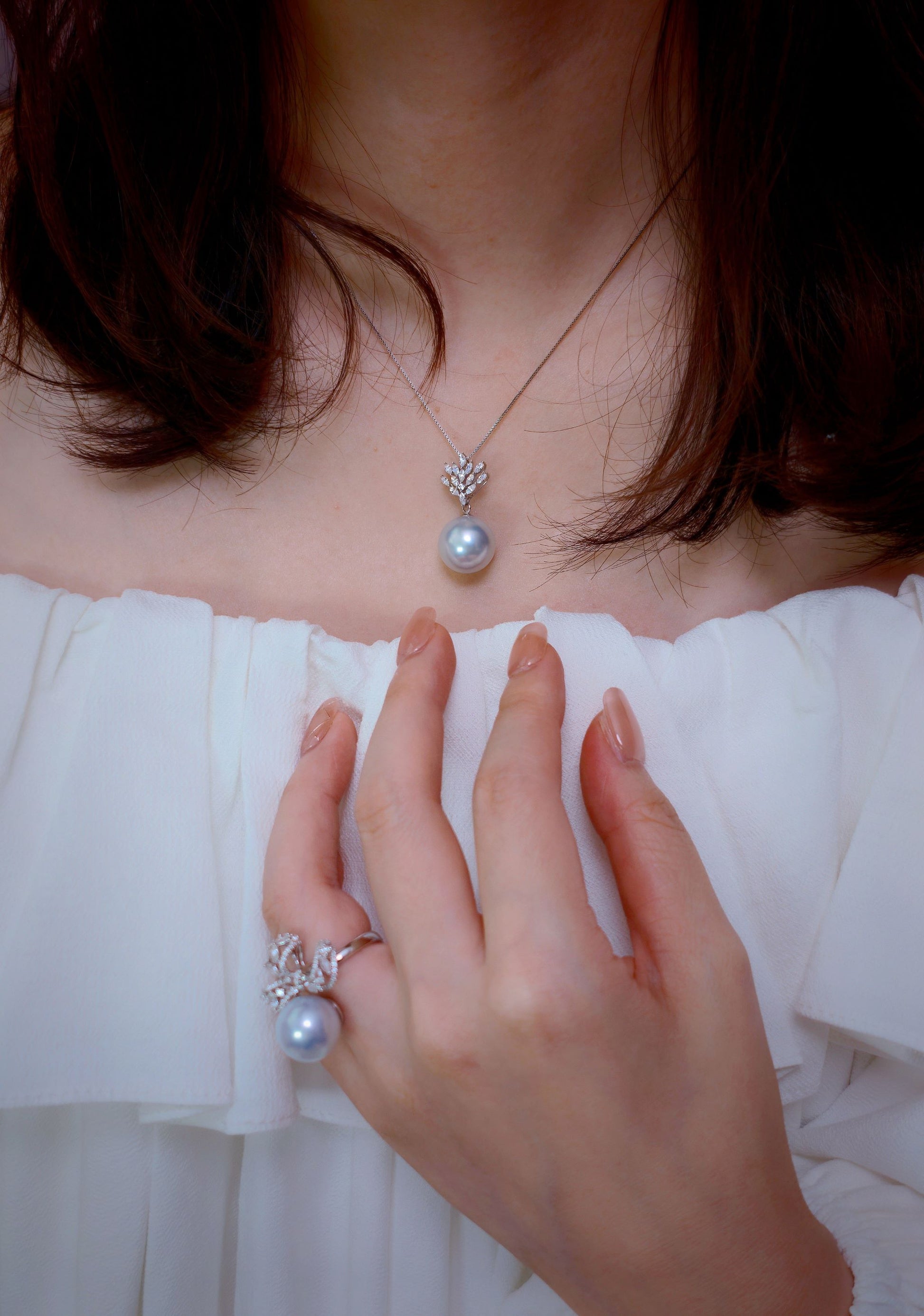 Cyrene Solitaire Bow Pearl Ring and Lone Drop Pearl Pendant worn together — matching rare silver-blue South Sea pearls in 18K white gold
