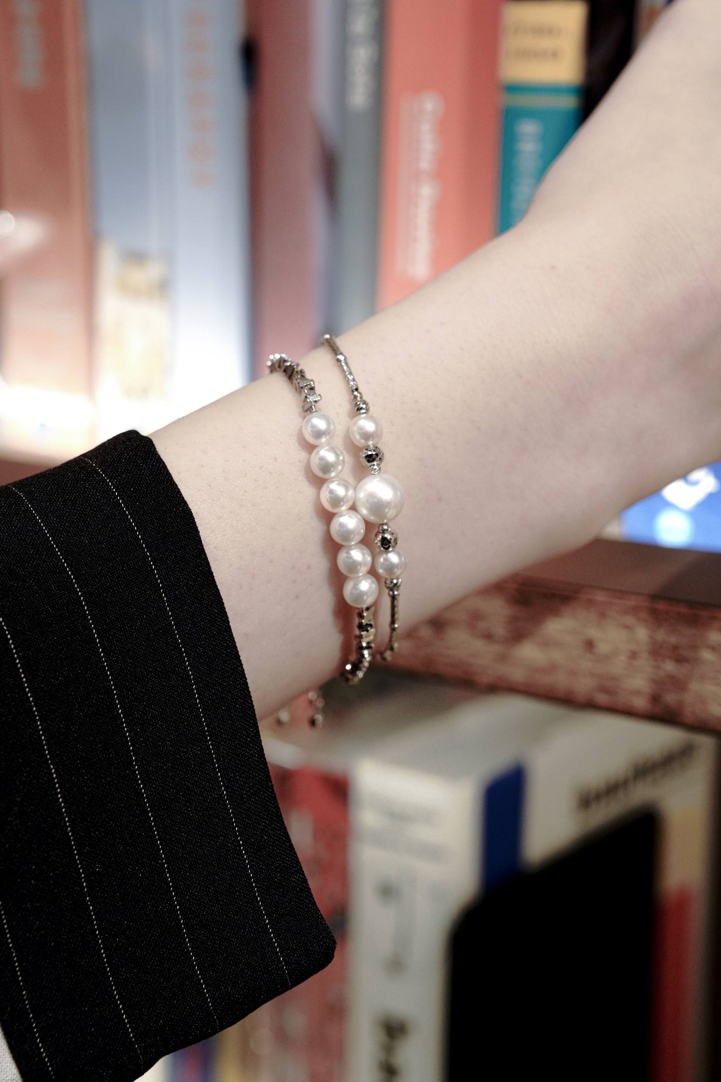 Detail of Cyrene's sophisticated trio pearl bracelet with intricate silver tube detailing, an ideal jewelry accessory for stylish workwear