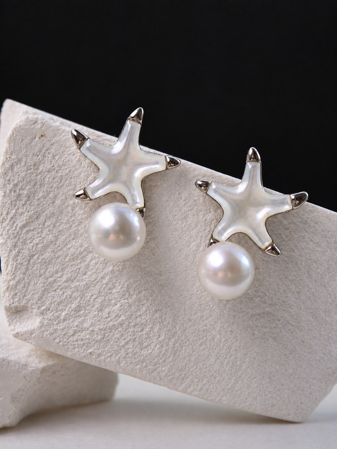 Starshore Pearl Earrings shown as a pair, with mother-of-pearl starfish inlays, sterling silver details and freshwater pearl drops
