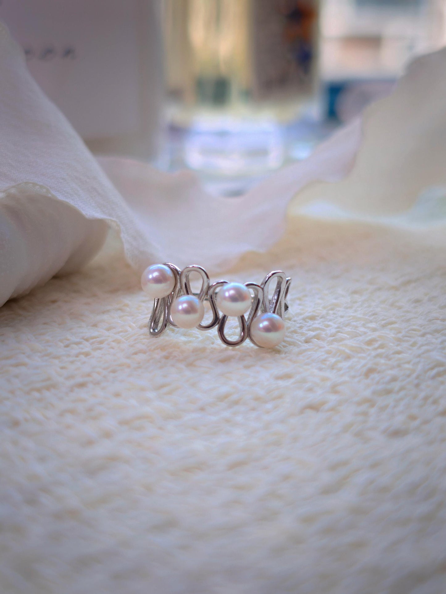 Cyrene Waveset Pearl Ring — 925 sterling silver wave band with four 5-6mm round freshwater pearls, flatlay close-up