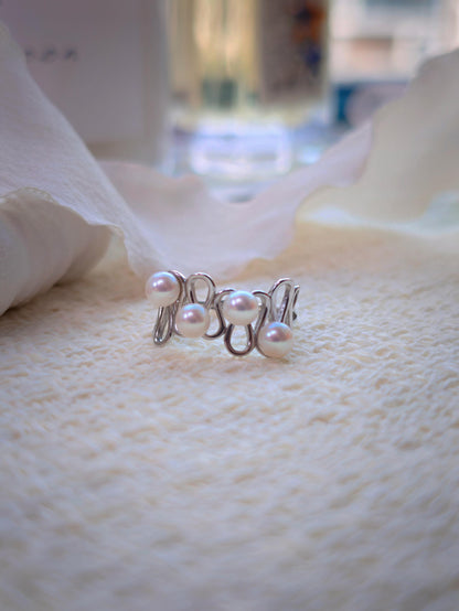 Cyrene Waveset Pearl Ring — 925 sterling silver wave band with four 5-6mm round freshwater pearls, flatlay close-up
