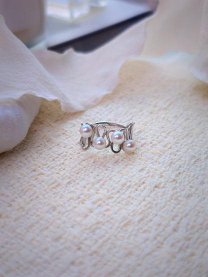 Cyrene Waveset Pearl Ring — open band sterling silver ring with four aurora freshwater pearl settings, flatlay
