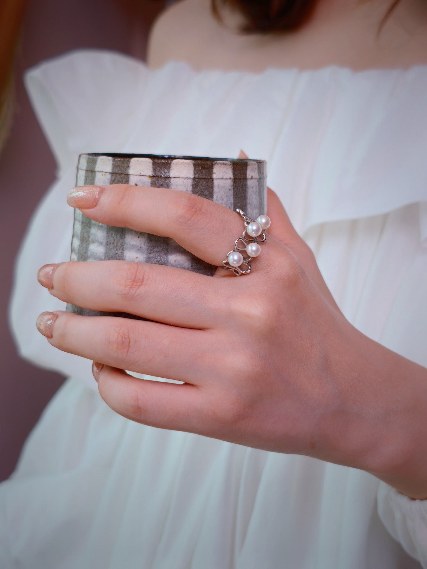 Cyrene Waveset Pearl Ring worn while holding ceramic cup — 925 silver and freshwater pearl wave ring, lifestyle