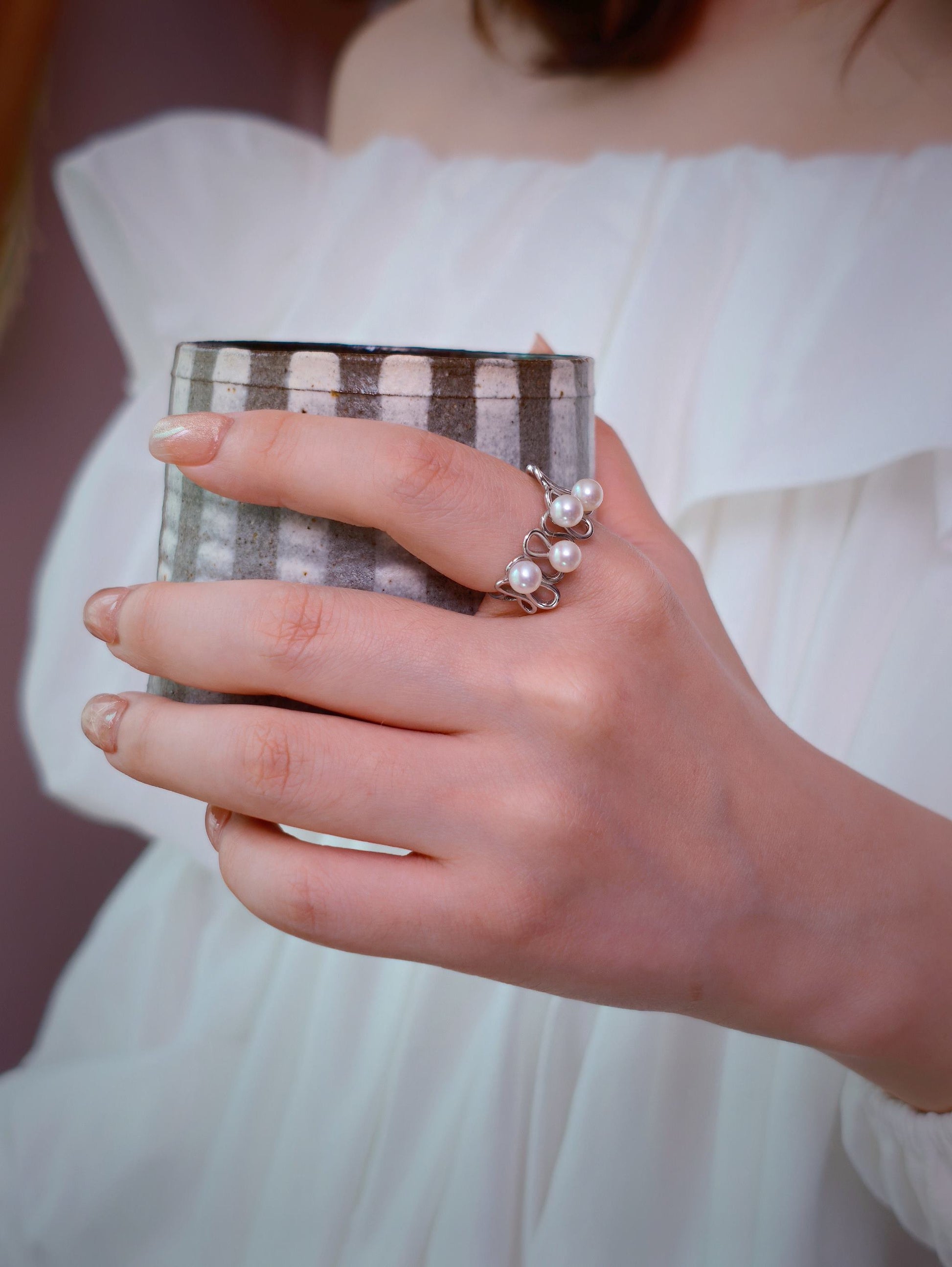 Cyrene Waveset Pearl Ring worn while holding ceramic cup — 925 silver and freshwater pearl wave ring, lifestyle
