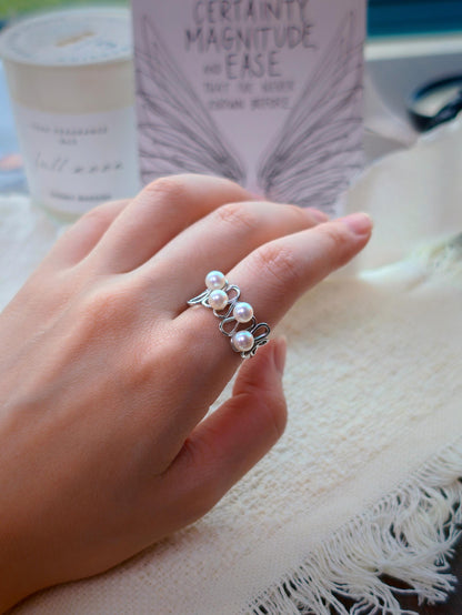 Cyrene Waveset Pearl Ring worn on finger — 925 silver wave open ring with round freshwater pearls, lifestyle shot